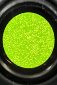 A close up of the light green color in a camera lens.
