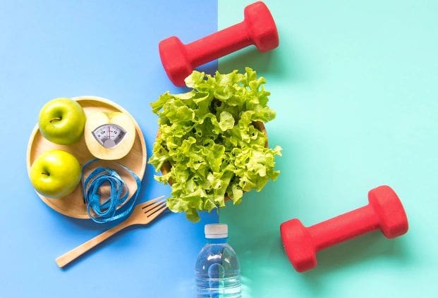 A bottle of water, lettuce and two red dumbbells.